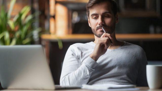 Man sitting in a dark room.