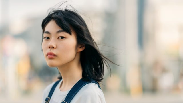 Girl looking away in the street.