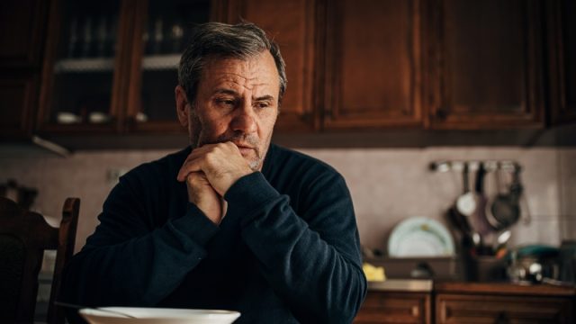 Man sitting at the table, thinking.