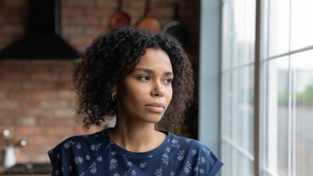 Young woman looking out the window.